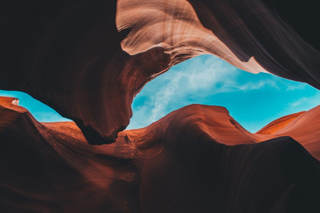 The majestic Arizona scenery features jagged rocks, a vast sky, and distinctive mountain formations.